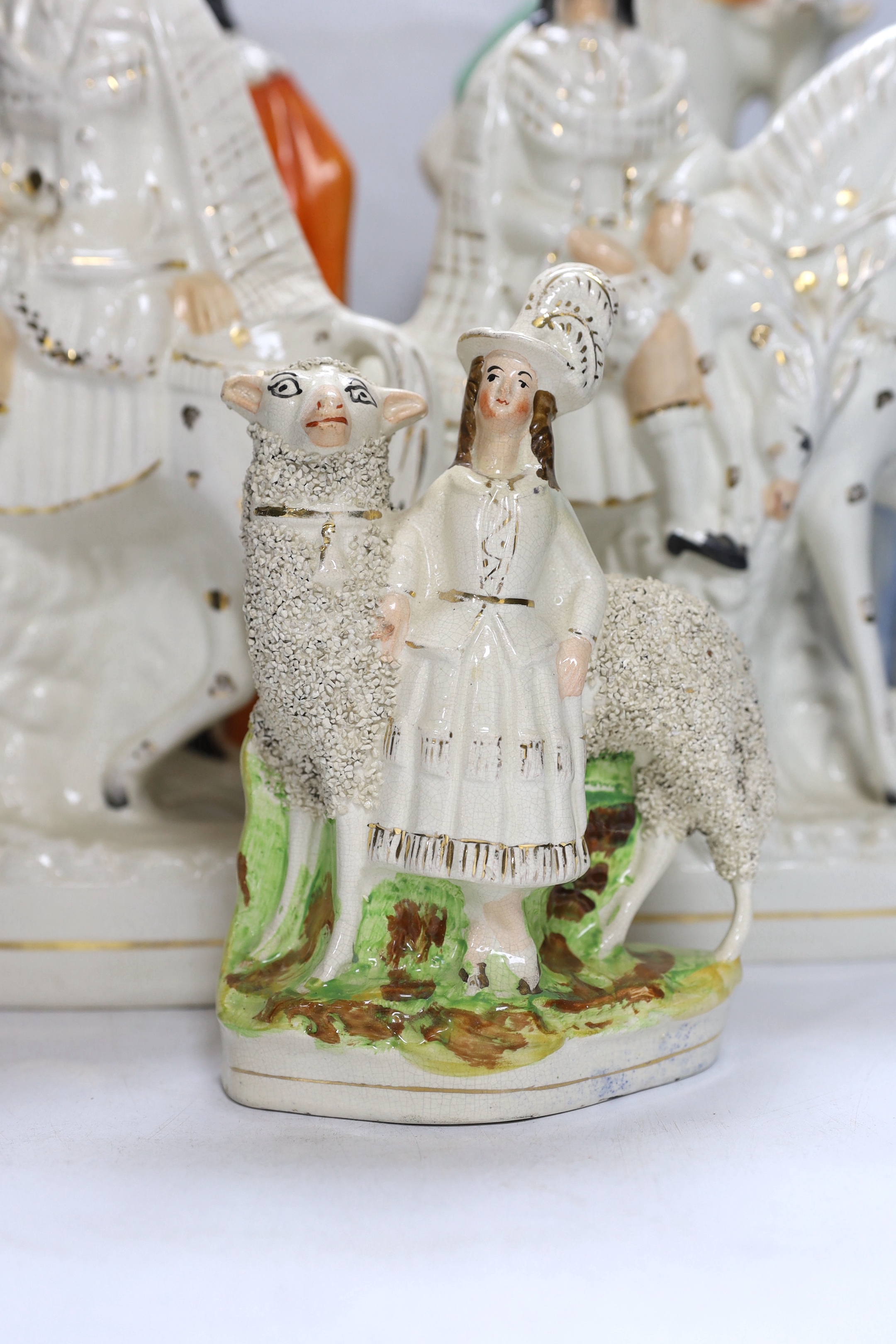 A pair of large mid 19th century Staffordshire pottery highland hunters, on horseback and three other Staffordshire pottery groups, largest 44 cm high (5)